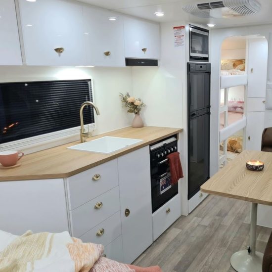 Great Escape Caravan with bunks interior with white decor